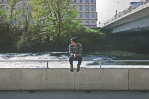 Teen Sitting on Bridge